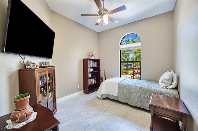 bedroom featuring baseboards and ceiling fan