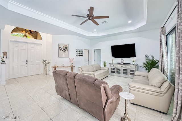 living room featuring crown molding, visible vents, recessed lighting, a raised ceiling, and a ceiling fan
