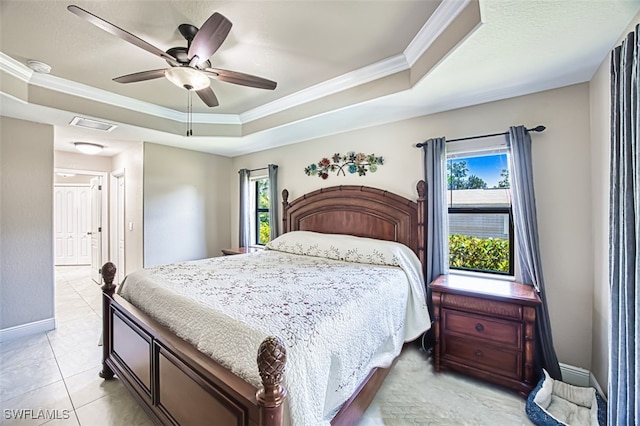 bedroom featuring visible vents, ornamental molding, baseboards, ceiling fan, and a raised ceiling