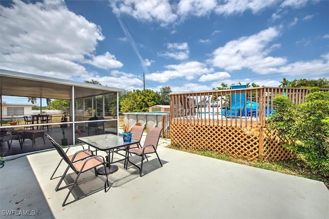 view of patio / terrace with a wooden deck, outdoor dining area, and an outdoor pool