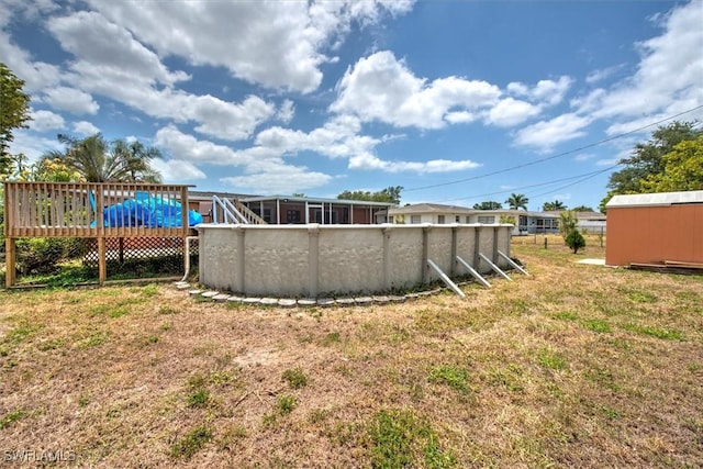 view of yard with a deck and an outdoor pool