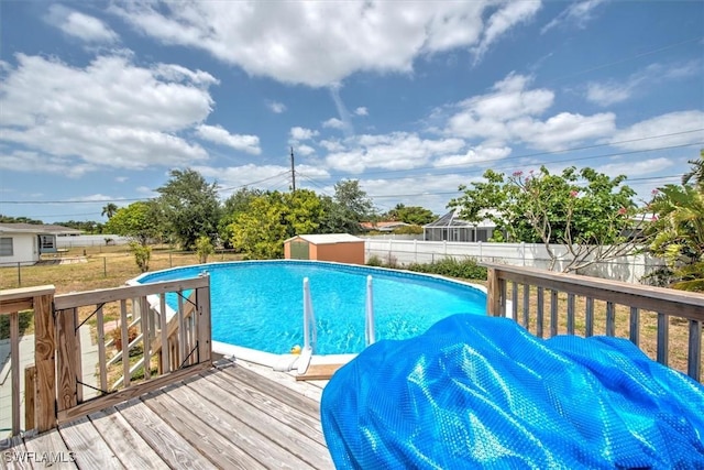 view of swimming pool featuring a deck, a fenced in pool, and a fenced backyard