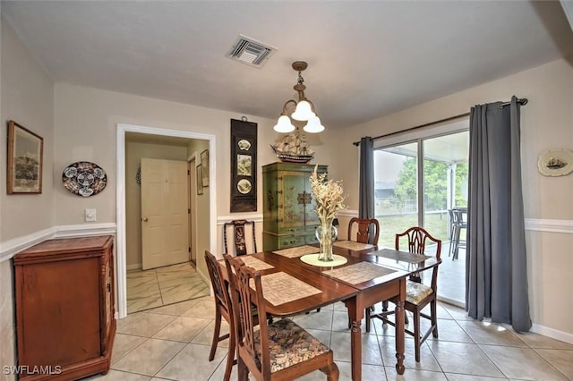 dining area with a chandelier, baseboards, and visible vents