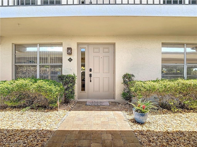 entrance to property with stucco siding