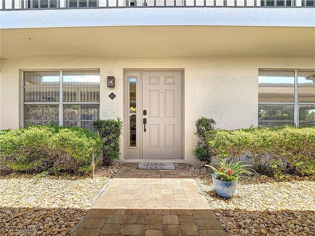 4211 SE 19th Pl Unit 1C, Cape Coral, FL 33904 - doorway to property with stucco siding