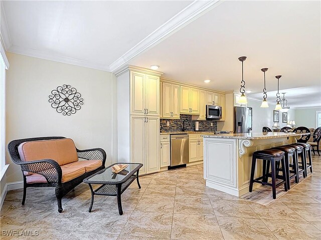 4211 SE 19th Pl Unit 1C, Cape Coral, FL 33904 - kitchen with appliances with stainless steel finishes, crown molding, cream cabinetry, a breakfast bar, and backsplash