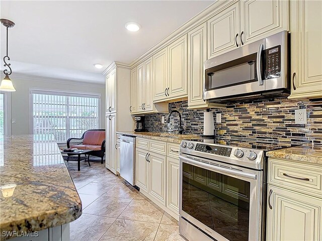 4211 SE 19th Pl Unit 1C, Cape Coral, FL 33904 - kitchen featuring appliances with stainless steel finishes, decorative backsplash, healthy amount of natural light, cream cabinetry, and ornamental molding