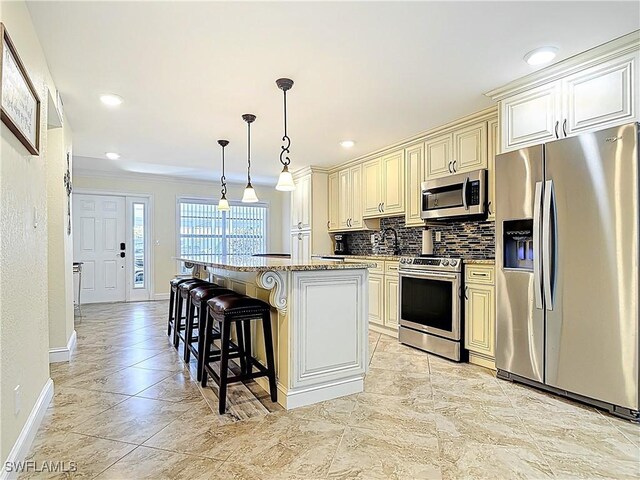 4211 SE 19th Pl Unit 1C, Cape Coral, FL 33904 - kitchen with appliances with stainless steel finishes, cream cabinetry, baseboards, decorative backsplash, and crown molding