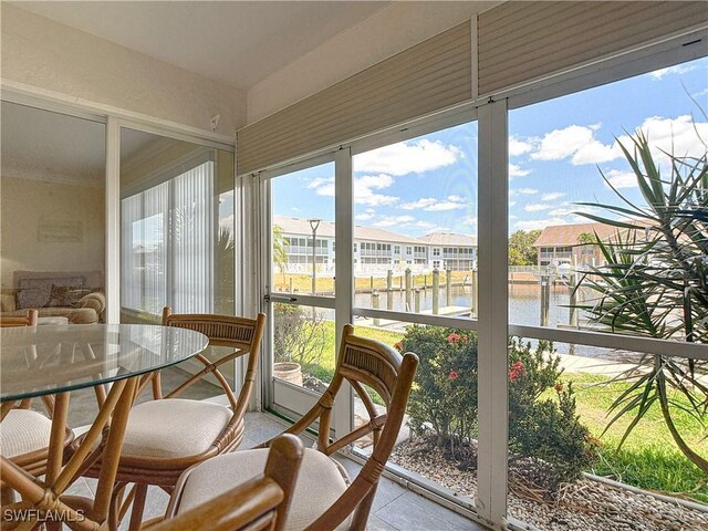 4211 SE 19th Pl Unit 1C, Cape Coral, FL 33904 - sunroom / solarium featuring a water view, a residential view, and tile patterned flooring