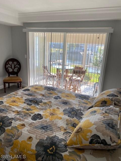 4211 SE 19th Pl Unit 1C, Cape Coral, FL 33904 - bedroom featuring crown molding, access to outside, and baseboards