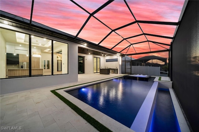 pool with a patio and glass enclosure