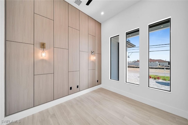 unfurnished bedroom with light wood-style floors, baseboards, and visible vents
