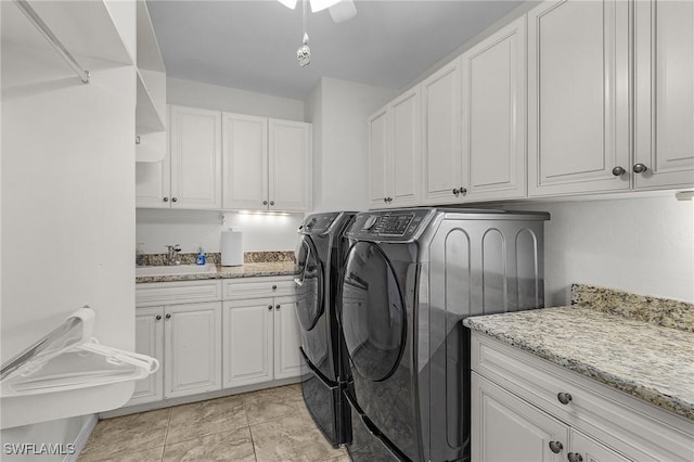 laundry room featuring washer and clothes dryer and cabinet space
