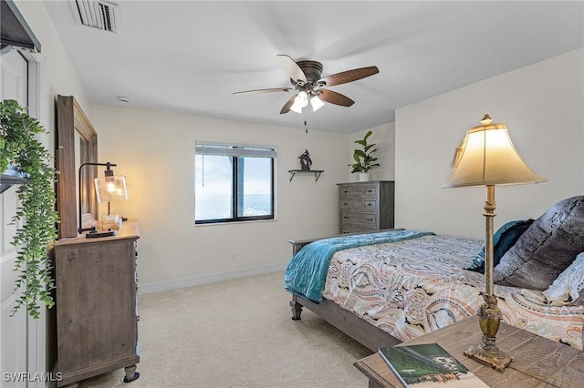 bedroom with light carpet, baseboards, and a ceiling fan