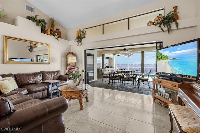 living room featuring high vaulted ceiling, light tile patterned flooring, and ceiling fan