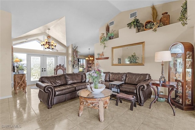 living room featuring french doors, high vaulted ceiling, and a chandelier