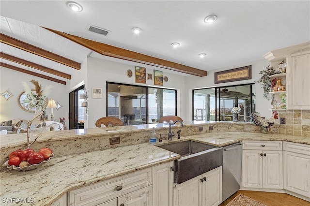 kitchen featuring a sink, stainless steel dishwasher, light stone countertops, open shelves, and tasteful backsplash