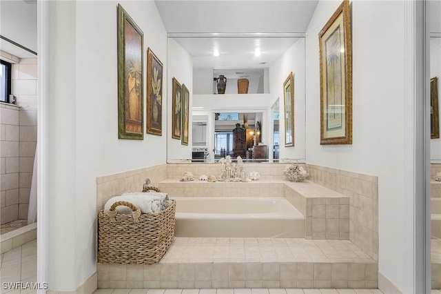 full bathroom featuring a garden tub and tile patterned flooring