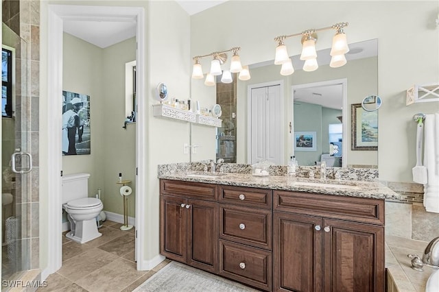 bathroom with a stall shower, connected bathroom, double vanity, toilet, and tile patterned floors