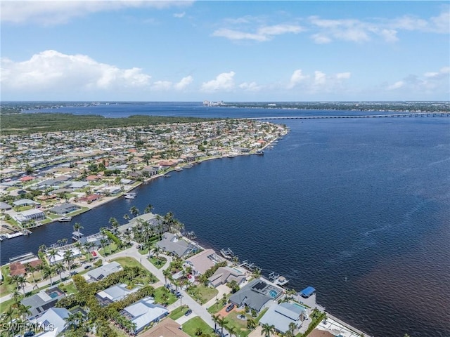 view of property location featuring a nearby body of water and nearby suburban area
