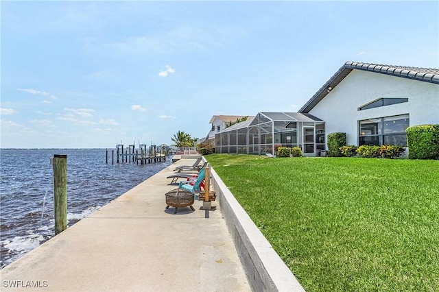 dock featuring a water view and a lawn