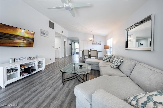 living area featuring baseboards, ceiling fan, wood finished floors, and visible vents