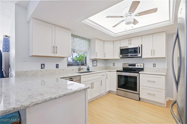 713 SW 39th Ter, Cape Coral, FL 33914 - kitchen with a sink, appliances with stainless steel finishes, a tray ceiling, and white cabinetry