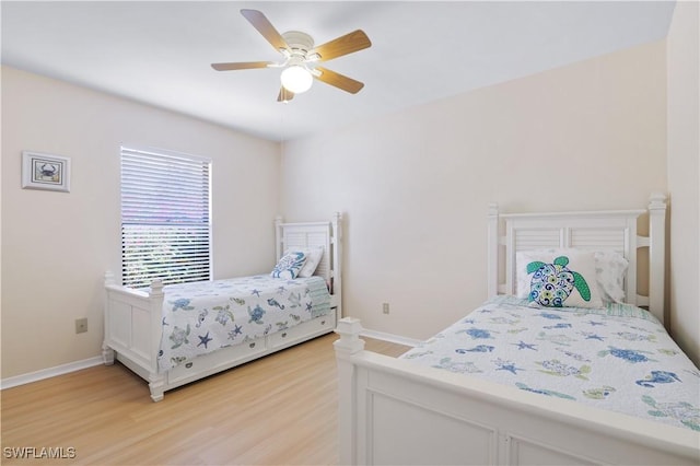 713 SW 39th Ter, Cape Coral, FL 33914 - bedroom with baseboards, ceiling fan, and light wood-type flooring