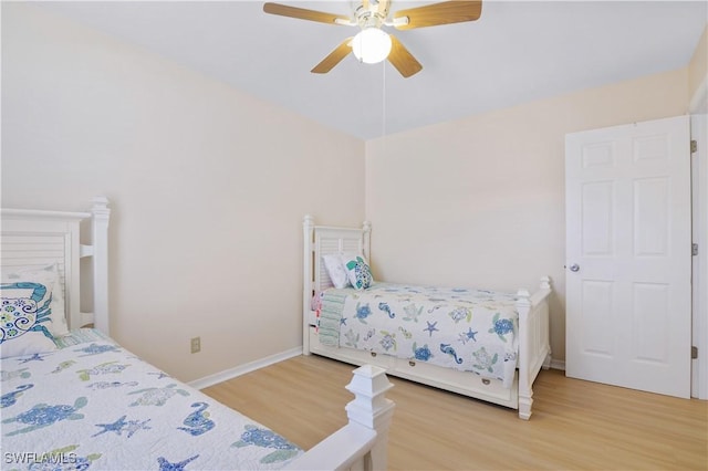 713 SW 39th Ter, Cape Coral, FL 33914 - bedroom with baseboards, light wood-style flooring, and ceiling fan