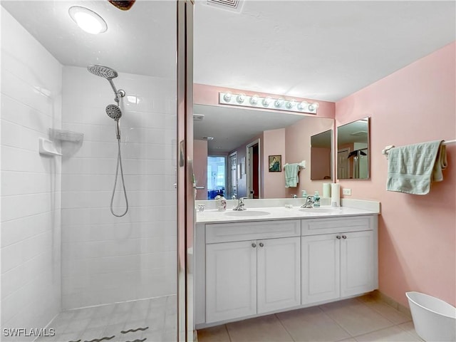 1787 Four Mile Cove Pkwy Unit 431, Cape Coral, FL 33990 - bathroom featuring tile patterned floors, double vanity, a tile shower, and a sink