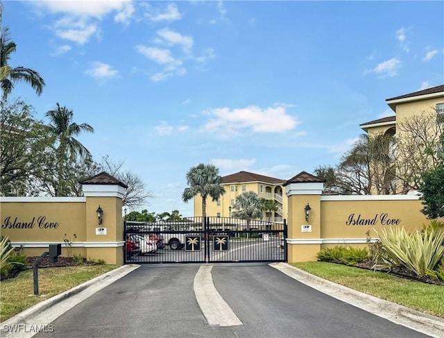 1787 Four Mile Cove Pkwy Unit 431, Cape Coral, FL 33990 - view of road featuring a gated entry, a gate, and curbs