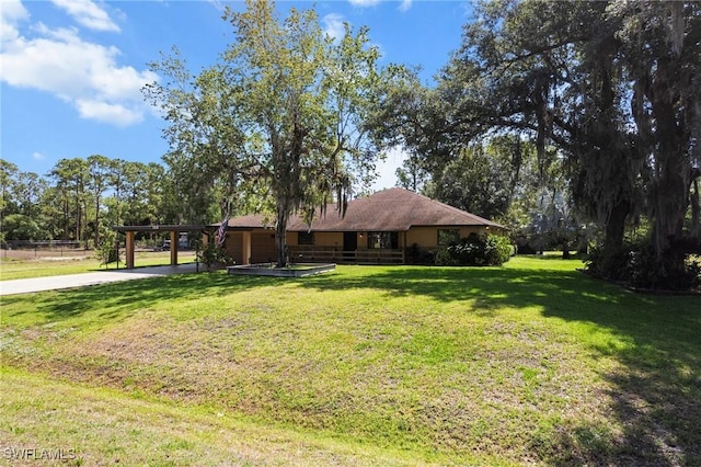 326 Mcarthur Ave, Lehigh Acres, FL 33936 - single story home featuring a front yard, concrete driveway, and an attached carport