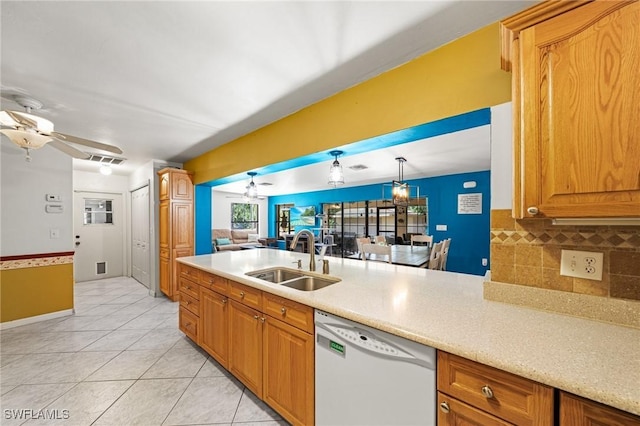 326 Mcarthur Ave, Lehigh Acres, FL 33936 - kitchen featuring dishwasher, a sink, a ceiling fan, backsplash, and light countertops