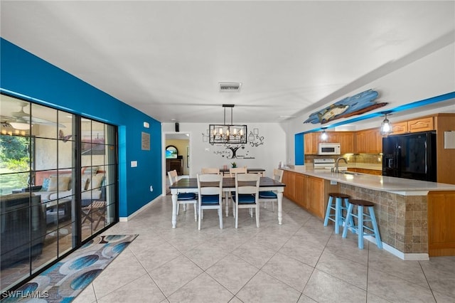 326 Mcarthur Ave, Lehigh Acres, FL 33936 - dining space featuring a chandelier and light tile patterned floors