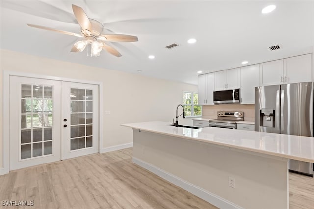 kitchen featuring a sink, appliances with stainless steel finishes, french doors, and visible vents