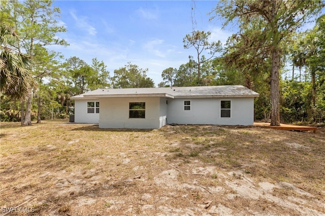 back of house featuring stucco siding