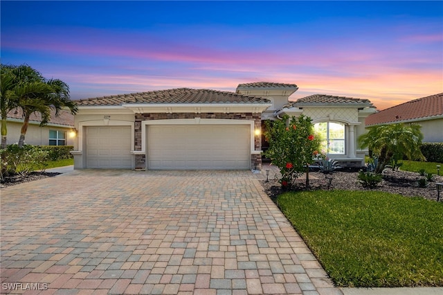 2094 Satsuma Ln, Naples, FL 34120 - view of front of home featuring decorative driveway, an attached garage, a tile roof, stucco siding, and stone siding