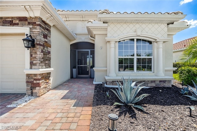 2094 Satsuma Ln, Naples, FL 34120 - view of exterior entry with stucco siding, stone siding, and a garage