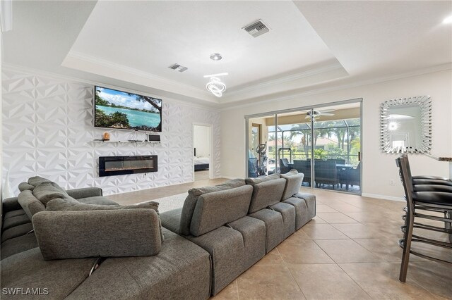 2094 Satsuma Ln, Naples, FL 34120 - living room featuring a raised ceiling, light tile patterned floors, a glass covered fireplace, ornamental molding, and baseboards