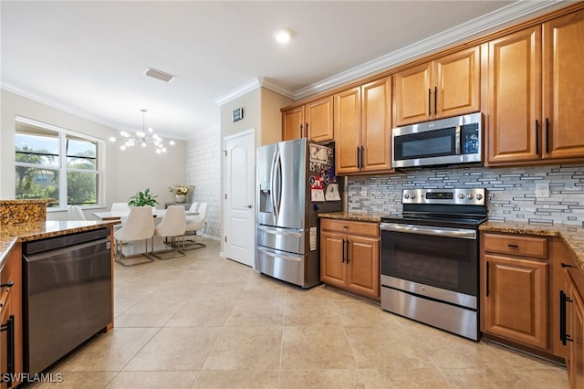 2094 Satsuma Ln, Naples, FL 34120 - kitchen with appliances with stainless steel finishes, ornamental molding, a chandelier, light stone countertops, and decorative backsplash