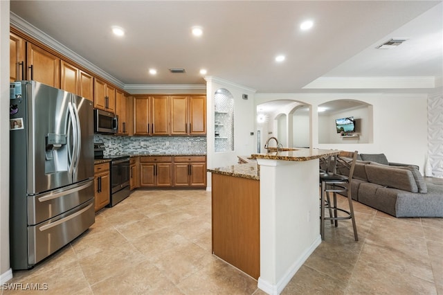 2094 Satsuma Ln, Naples, FL 34120 - kitchen featuring stainless steel appliances, ornamental molding, light stone countertops, a sink, and tasteful backsplash