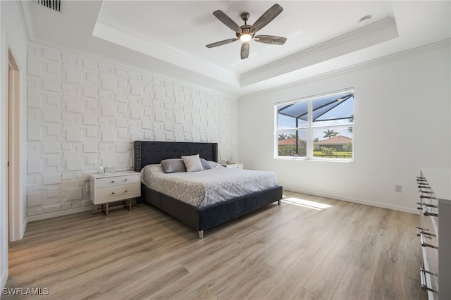 2094 Satsuma Ln, Naples, FL 34120 - bedroom featuring a raised ceiling, light wood-style floors, ornamental molding, ceiling fan, and baseboards