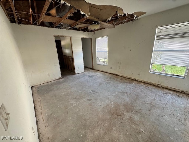 unfurnished bedroom with unfinished concrete floors