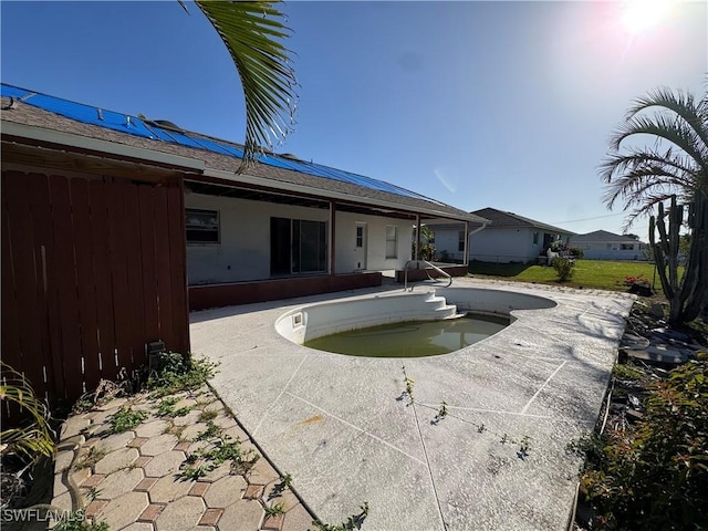 view of swimming pool with a patio and an empty pool