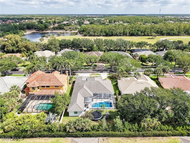 birds eye view of property with a water view and a residential view