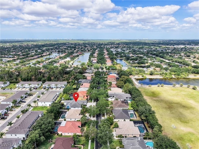 drone / aerial view featuring a water view and a residential view