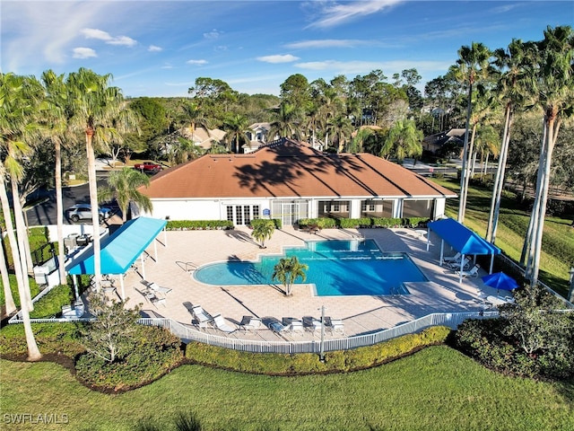 community pool with french doors and a patio area