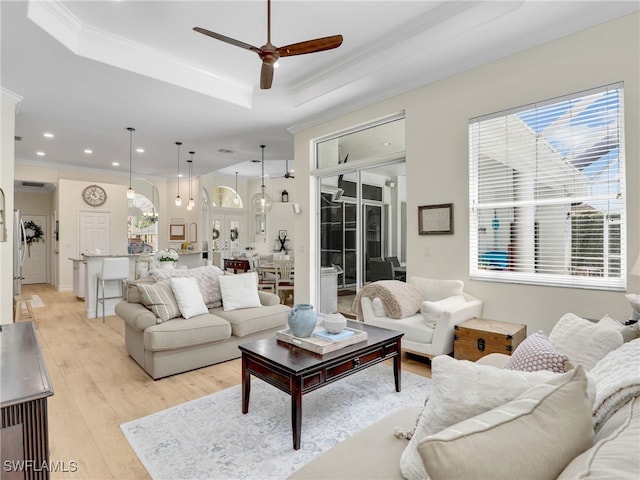 living area with light wood-type flooring, ornamental molding, ceiling fan, and recessed lighting