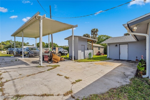 view of patio featuring driveway and a carport