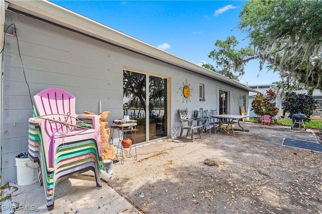 view of patio with area for grilling and outdoor dining area